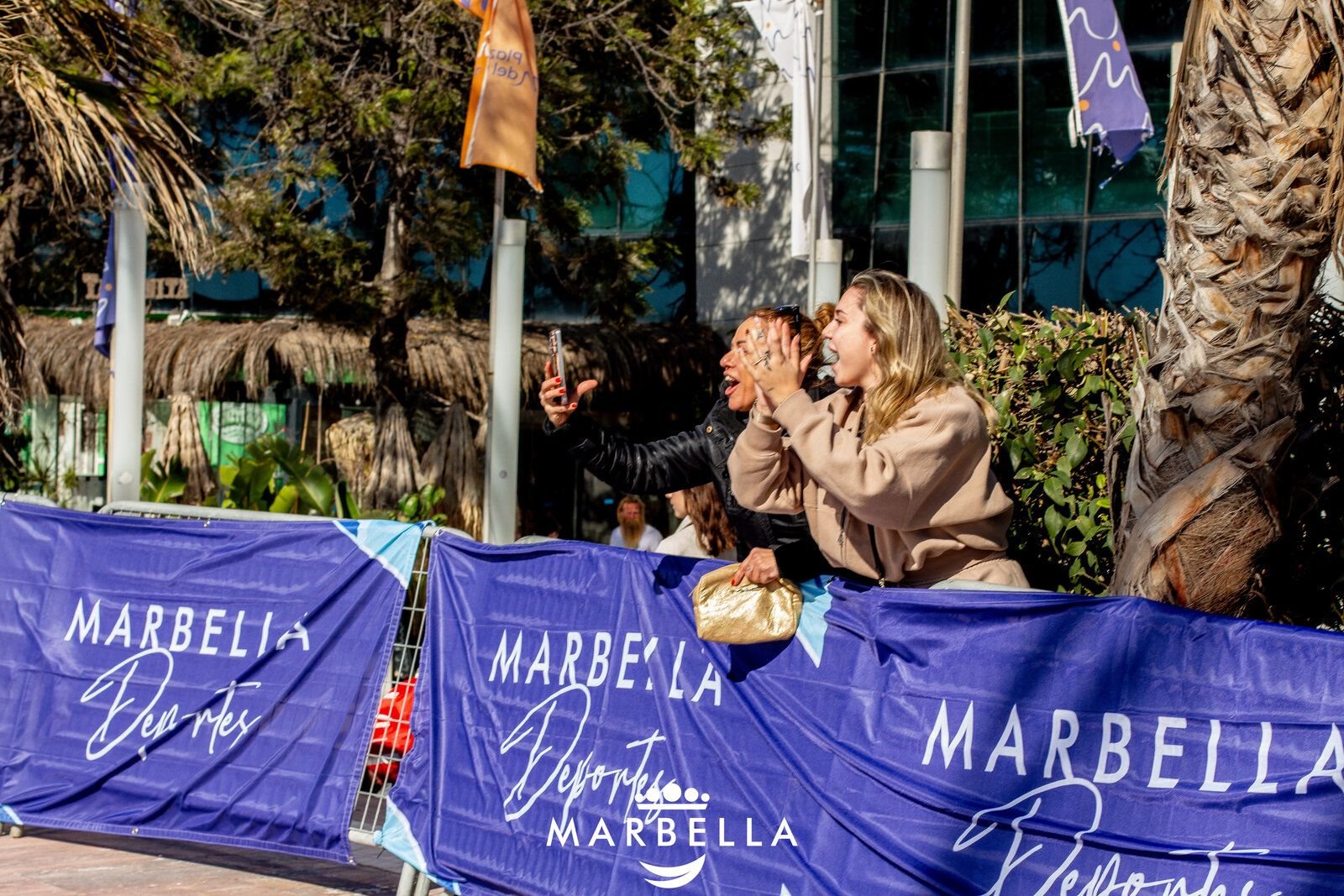 Supporters cheering on runners at a race checkpoint