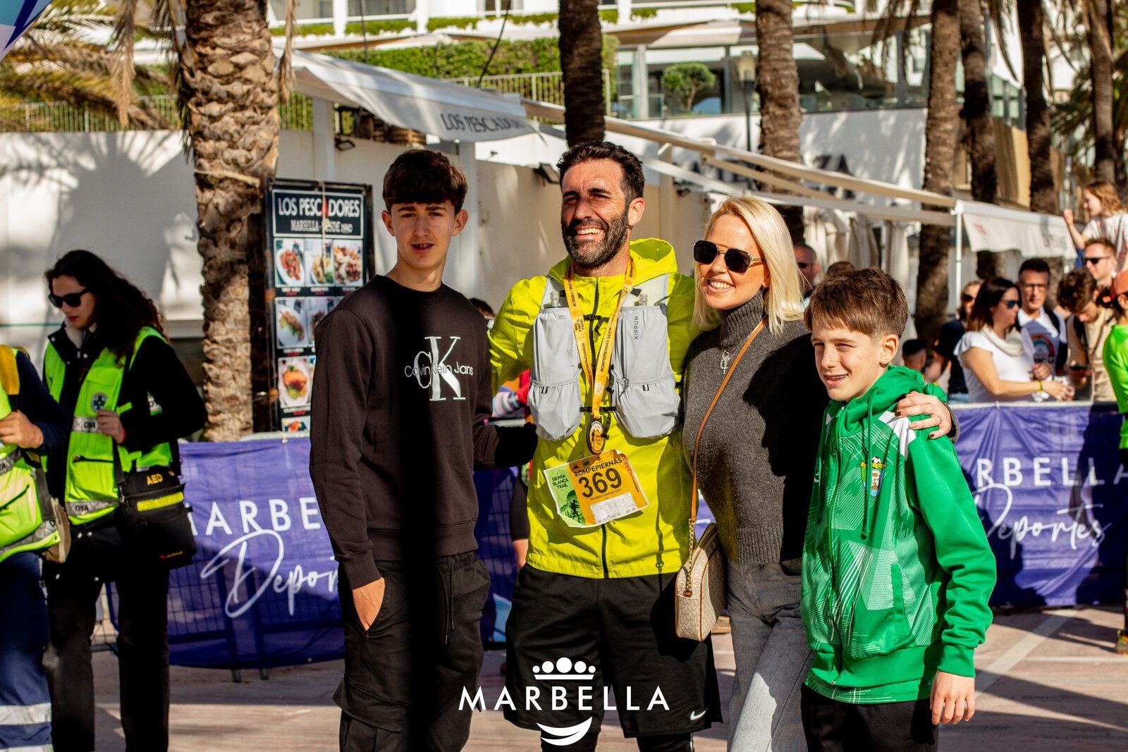 Supporters celebrating with runners at an aid station